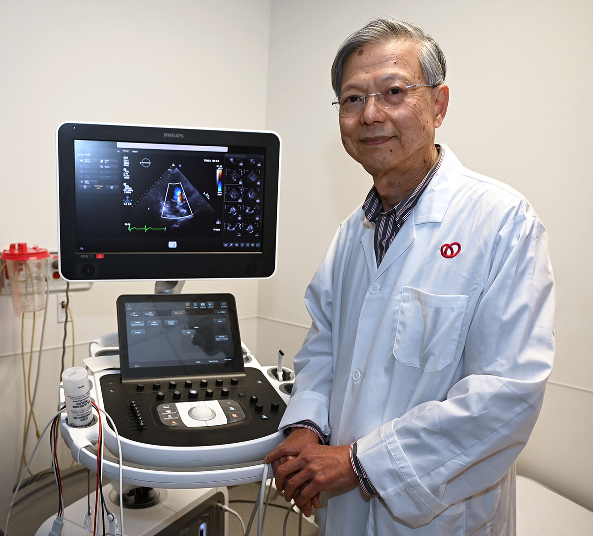 Standing beside echocardiography equipment, Dr. Chan highlights the essential role of imaging in understanding heart function and diagnosis.