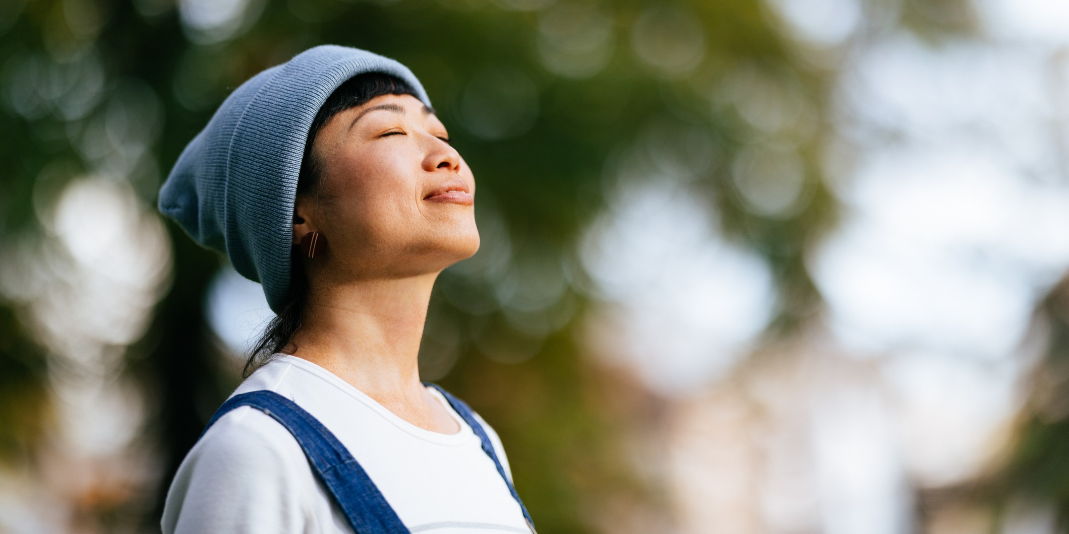 Smiling Woman Enjoying Fresh Air In The City Park