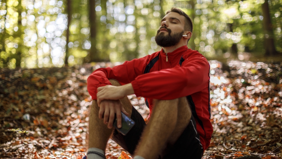 Young man sitting and relaxing in a forest