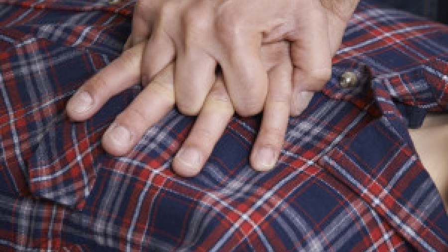 Man Using CPR Technique On Dummy