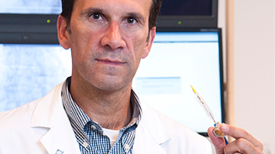 Dr. Marino Labinaz holding a TAVI catheter and valve