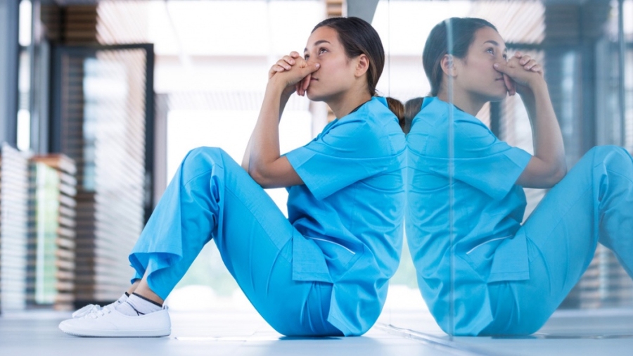 Female nurse sitting on the ground