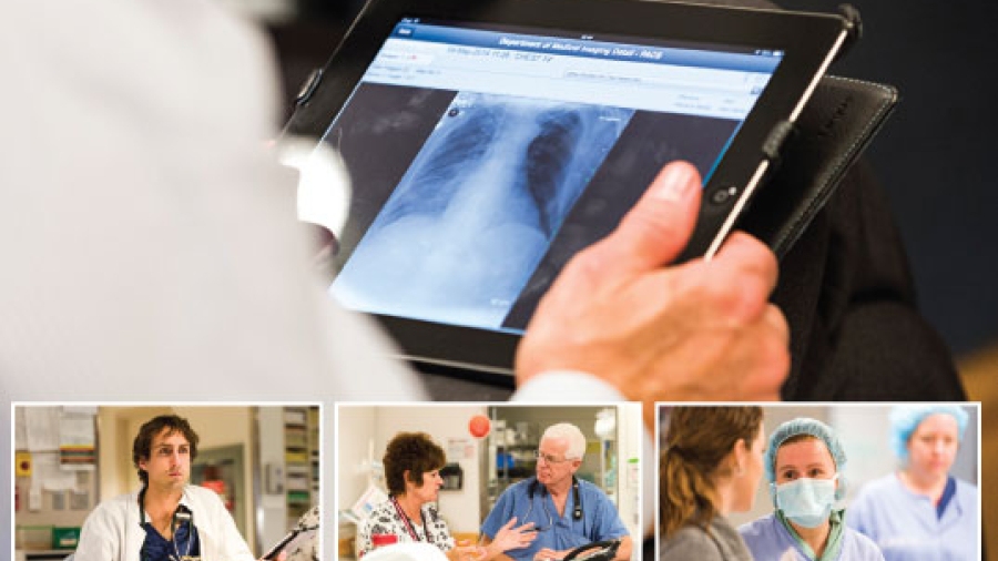 A health worker looking at a digital X-Ray on a tablet