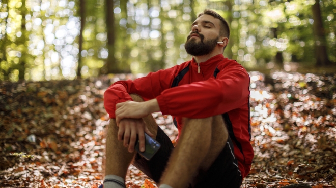 Young man sitting and relaxing in a forest