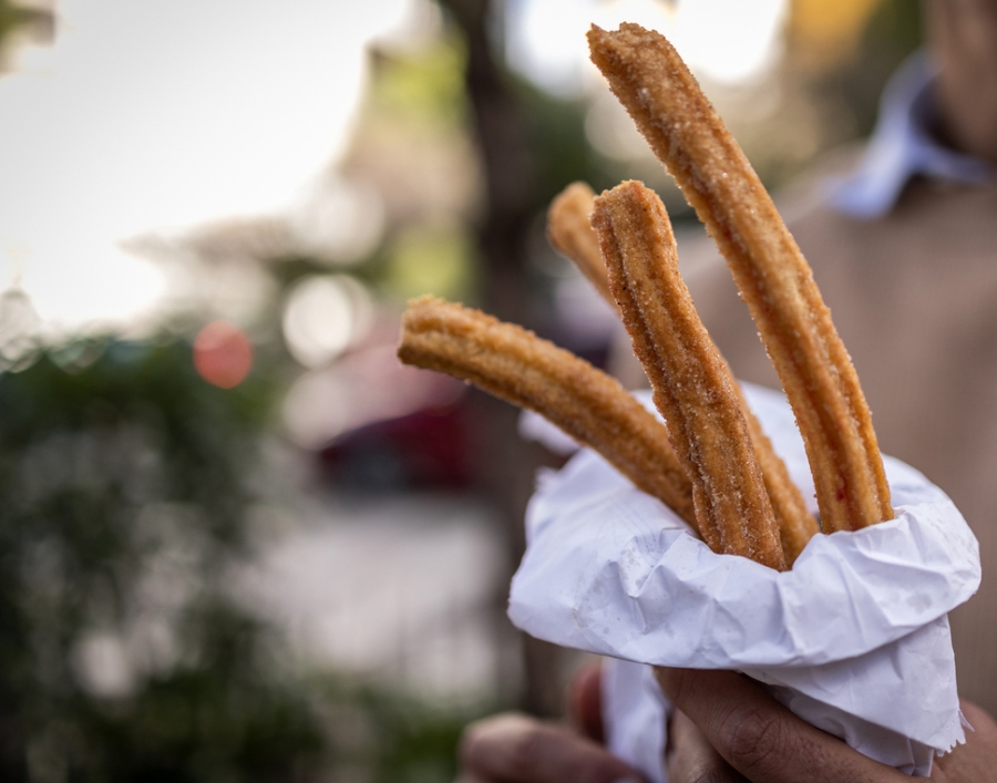 Churros are deep-fried dough pastries, typically coated in sugar and often served with chocolate or caramel dipping sauce.