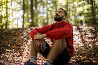 Young man sitting and relaxing in a forest