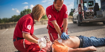Two emergency workers tend to a victim of cardiac arrest