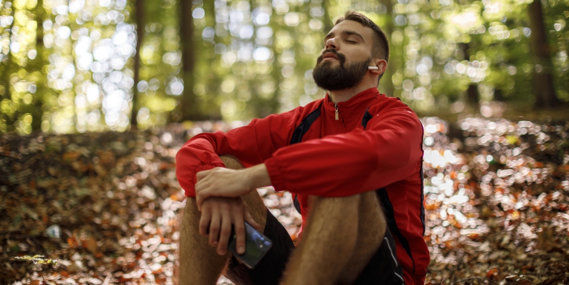 Young man sitting and relaxing in a forest