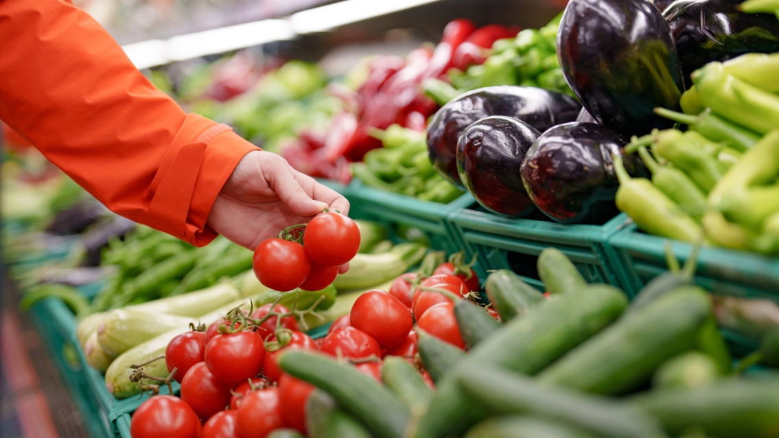 a person shopping vegetables in a store