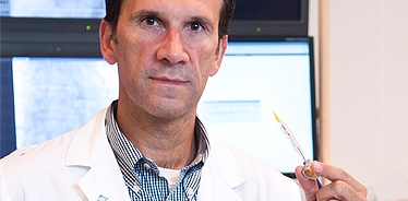 Dr. Marino Labinaz holding a TAVI catheter and valve