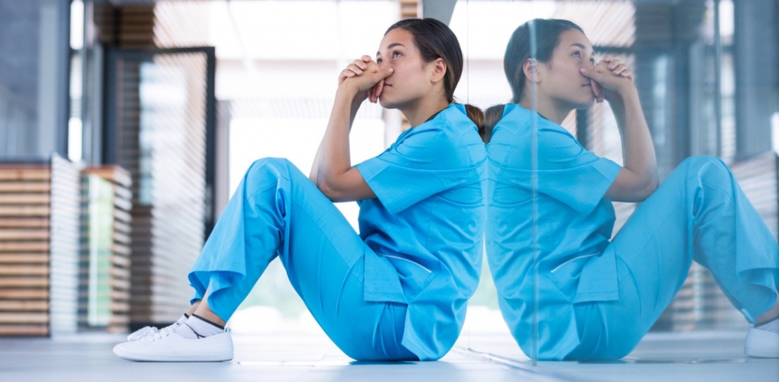 Female nurse sitting on the ground